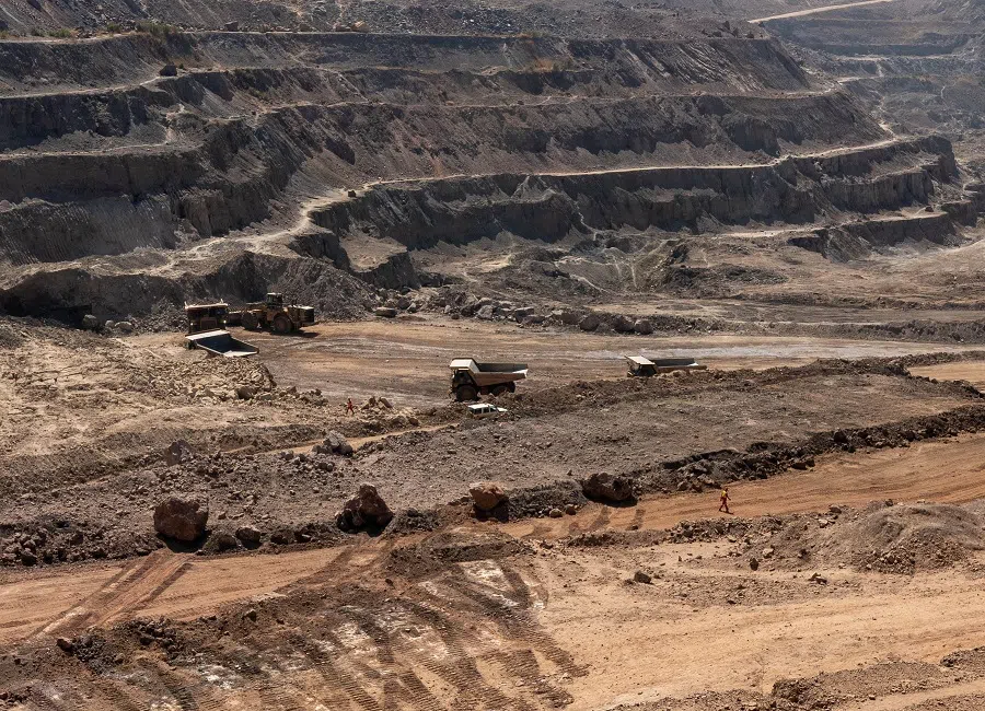 Trucks haul away ore from a pit in Tenke Fungurume Mine, one of the largest copper and cobalt mines in the world, owned by Chinese company CMOC, in southeastern Democratic Republic of the Congo on 17 June 2023. (Emmet Livingstone/AFP)