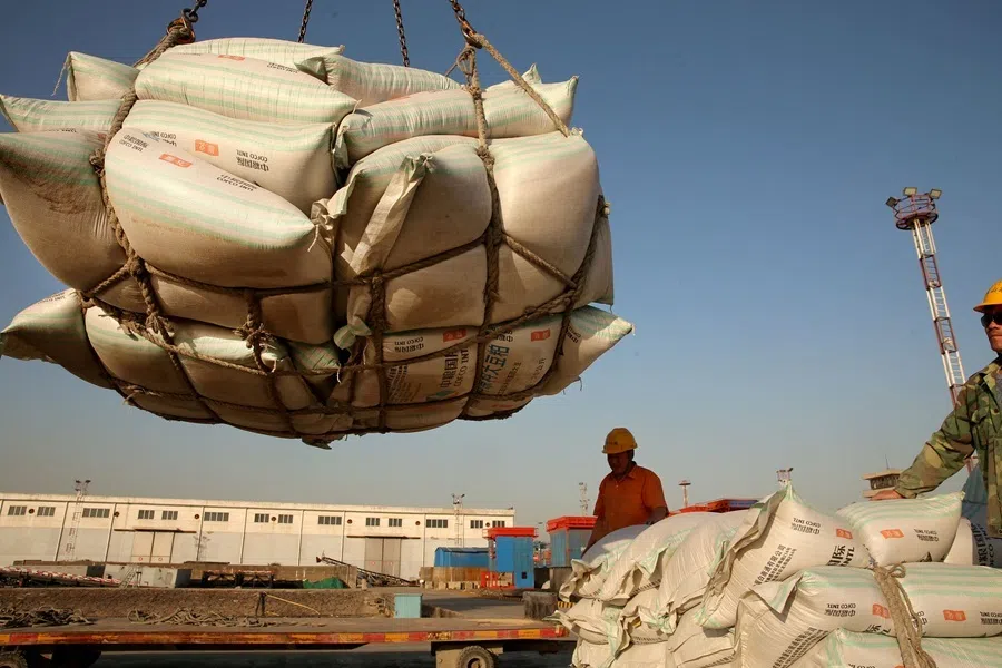Workers transport imported soybean products at a port in Nantong, Jiangsu province, China, on 9 April 2018.
