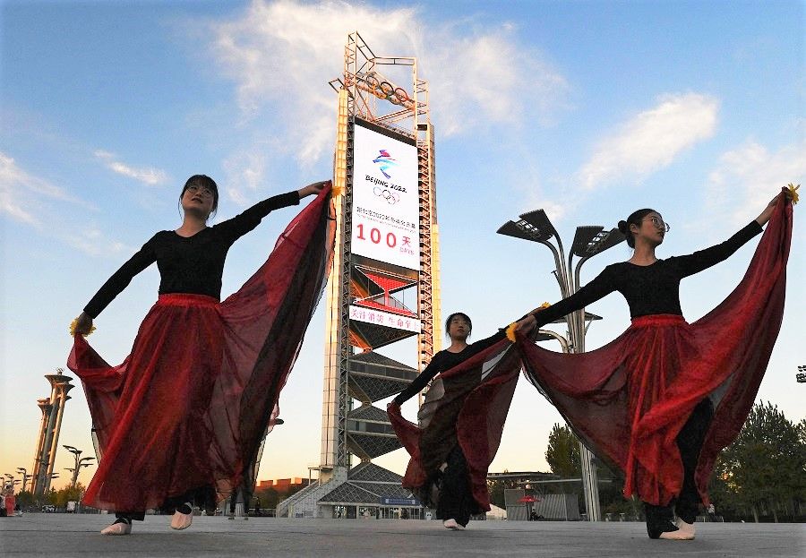 Dancers perform in front of the countdown clock showing 100 days until the opening of the 2022 Beijing Winter Olympics, at the Olympic Park in Beijing, China, on 27 October 2021. (Noel Celis/AFP)