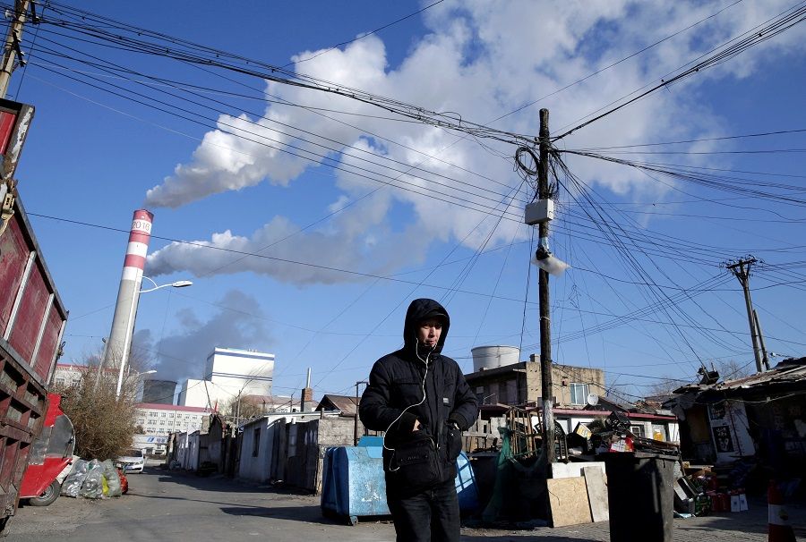 A man walks near a coal-fired power plant in Harbin, Heilongjiang province, China, 27 November 2019. (Jason Lee/File Photo/Reuters)