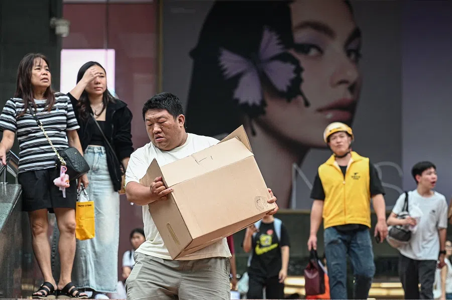 People outside a shopping mall in Guangzhou, Guangdong province, China, on 18 April 2025.