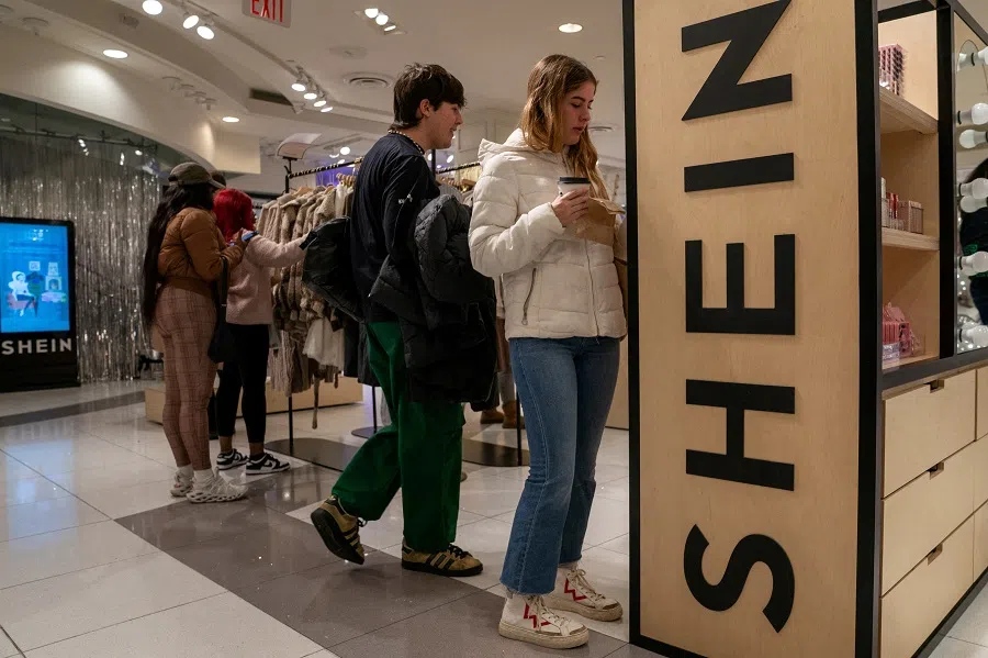People shop at the SHEIN Holiday pop-up shop inside of Times Squares Forever 21 in New York City, US, on 10 November 2023. (David 'Dee' Delgado/Reuters)