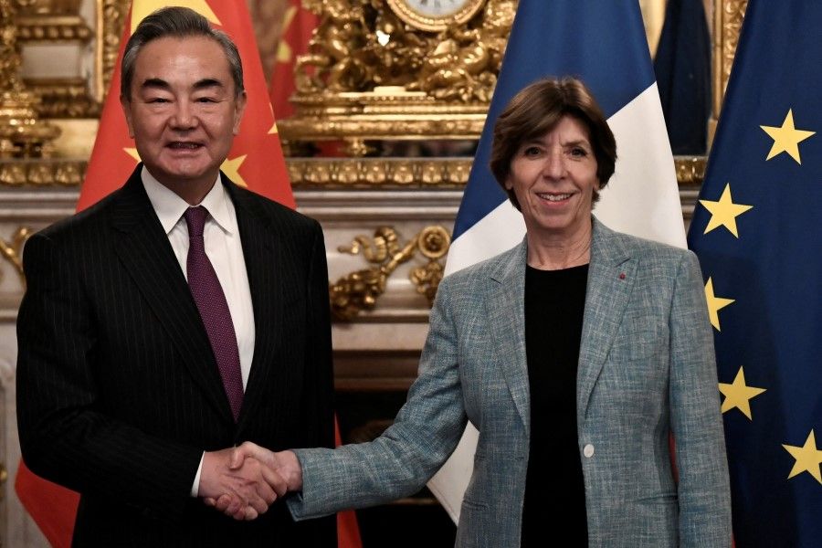 China's top diplomat Wang Yi shakes hands with French Foreign and European Affairs Minister Catherine Colonna as they attend a meeting in Paris, France, 15 February 2023. (Stephane De Sakutin/Pool via Reuters)