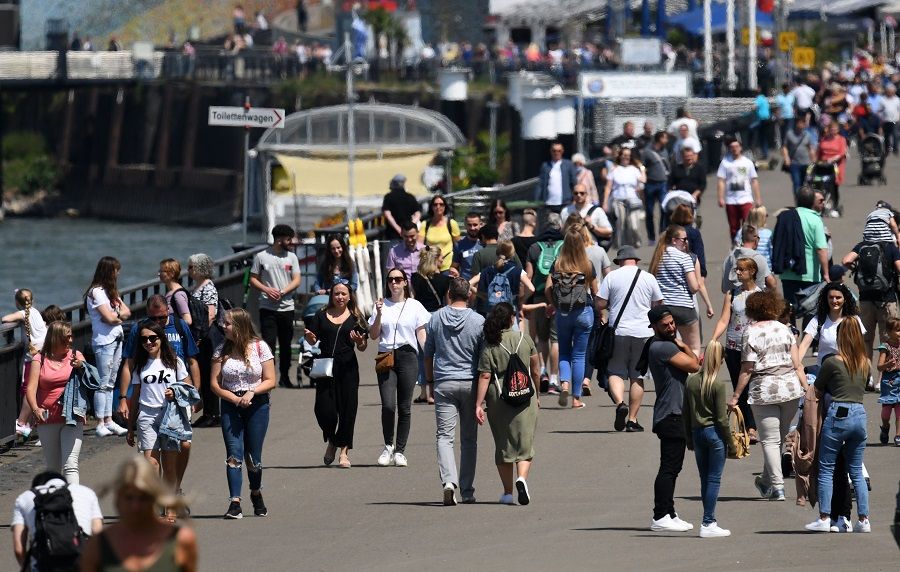 People walk at the Rhine promenade of Dusseldorf, Germany, on 12 July 2020. (Photo by Ina Fassbender/AFP)