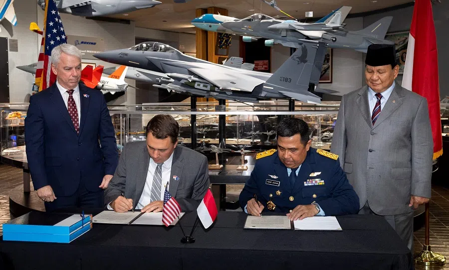 This handout photo released by Boeing on 22 August 2023 shows Indonesian Defence Minister Prabowo Subianto (R) witnessing the signing of a memorandum of understanding committing to the sale on 21 August 2023 between Indonesian airforce and Boeing officials at the company's St. Louis facility. (Eric Shindelbower/Boeing/AFP)
