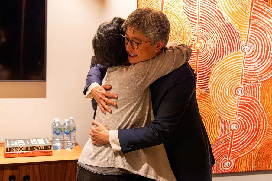 This handout photograph taken on 11 October 2023 and released by Australia's Department of Foreign Affairs and Trade shows Australian Foreign Minister Penny Wong (right) hugging Australian journalist Cheng Lei upon her arrival at the airport in Melbourne, Australia. (Sarah Hodges/Australia's Department of Foreign Affairs and Trade (DFAT)/AFP)