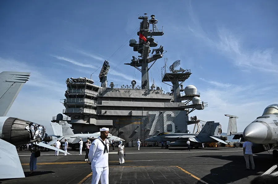Sailors stand on the deck of the USS Ronald Reagan, a US Navy Nimitz-class nuclear-powered aircraft carrier, during a port visit in Danang, Vietnam, on 26 June 2023. (Nhac Nguyen/AFP)
