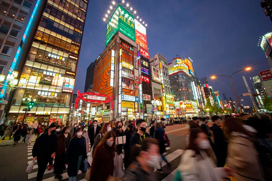 Pedestrians cross a street in Tokyo's Shinjuku area on 12 December 2020. (Kazuhiro Nogi/AFP)