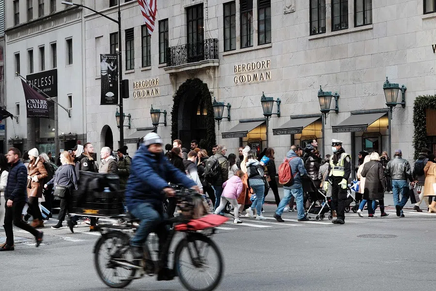 People walk past Bergdorf Goodman department store on 5th Avenue in Manhattan on 5 December 2022 in New York City, US. (Spencer Platt/Getty Images/AFP)