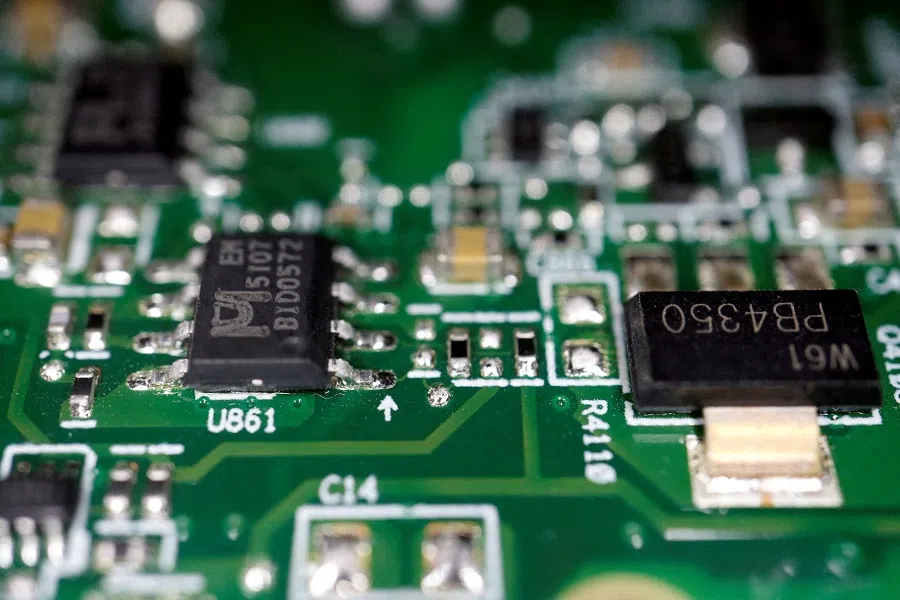 Semiconductor chips are seen on a printed circuit board in this illustration picture taken 17 February 2023. (Florence Lo/Reuters)