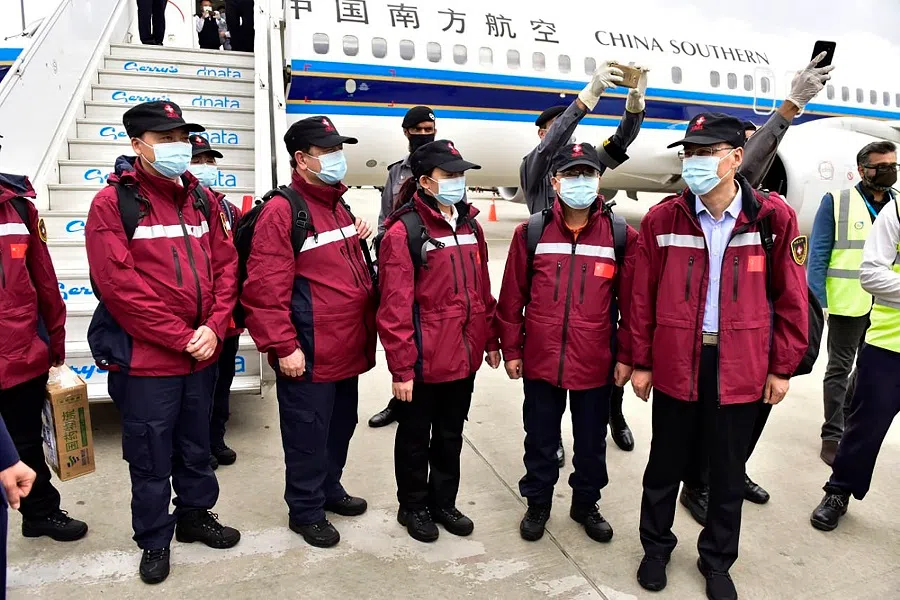In this handout photograph taken and released by Pakistan's Press Information Department on 28 March 2020, Chinese doctors arrive at the Islamabad International airport in Islamabad, Pakistan. (Press Information Department/AFP)