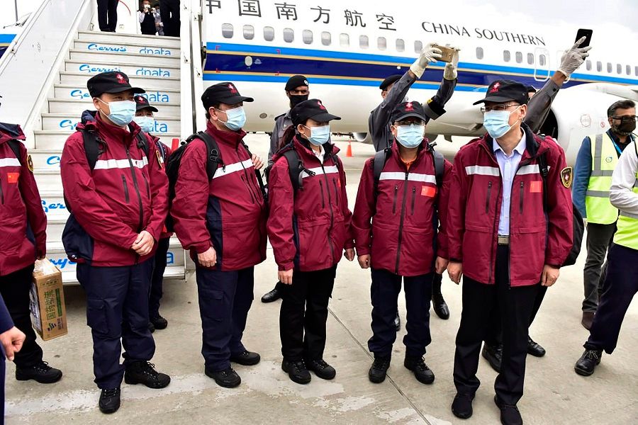 In this handout photograph taken and released by Pakistan's Press Information Department on 28 March 2020, Chinese doctors arrive at the Islamabad International airport in Islamabad, Pakistan. (Press Information Department/AFP)