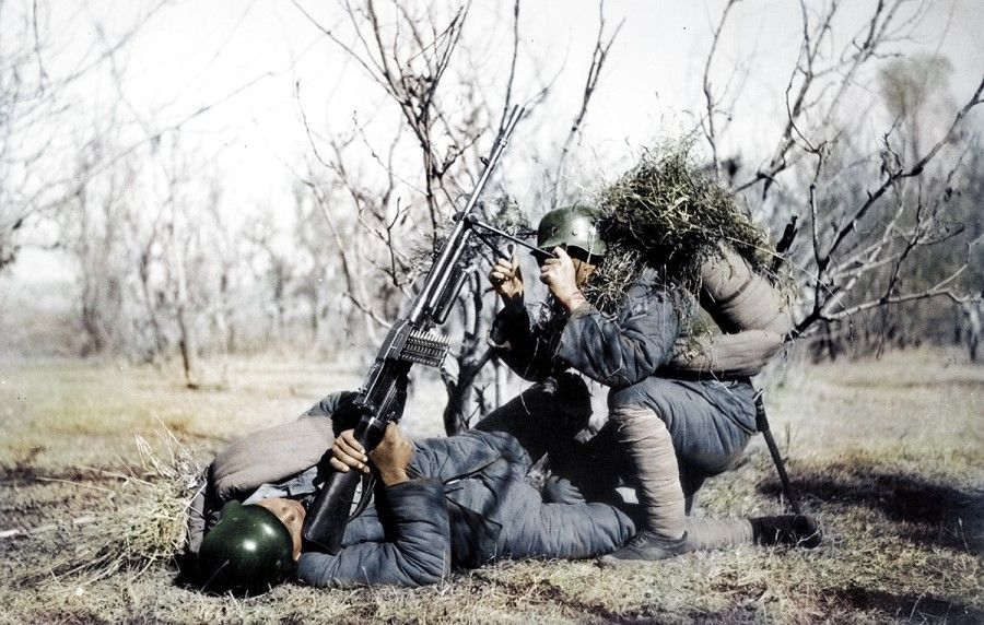 October 1937, two Chinese soldiers firing at Japanese aircraft with machine guns at a periphery position in Taiyuan.