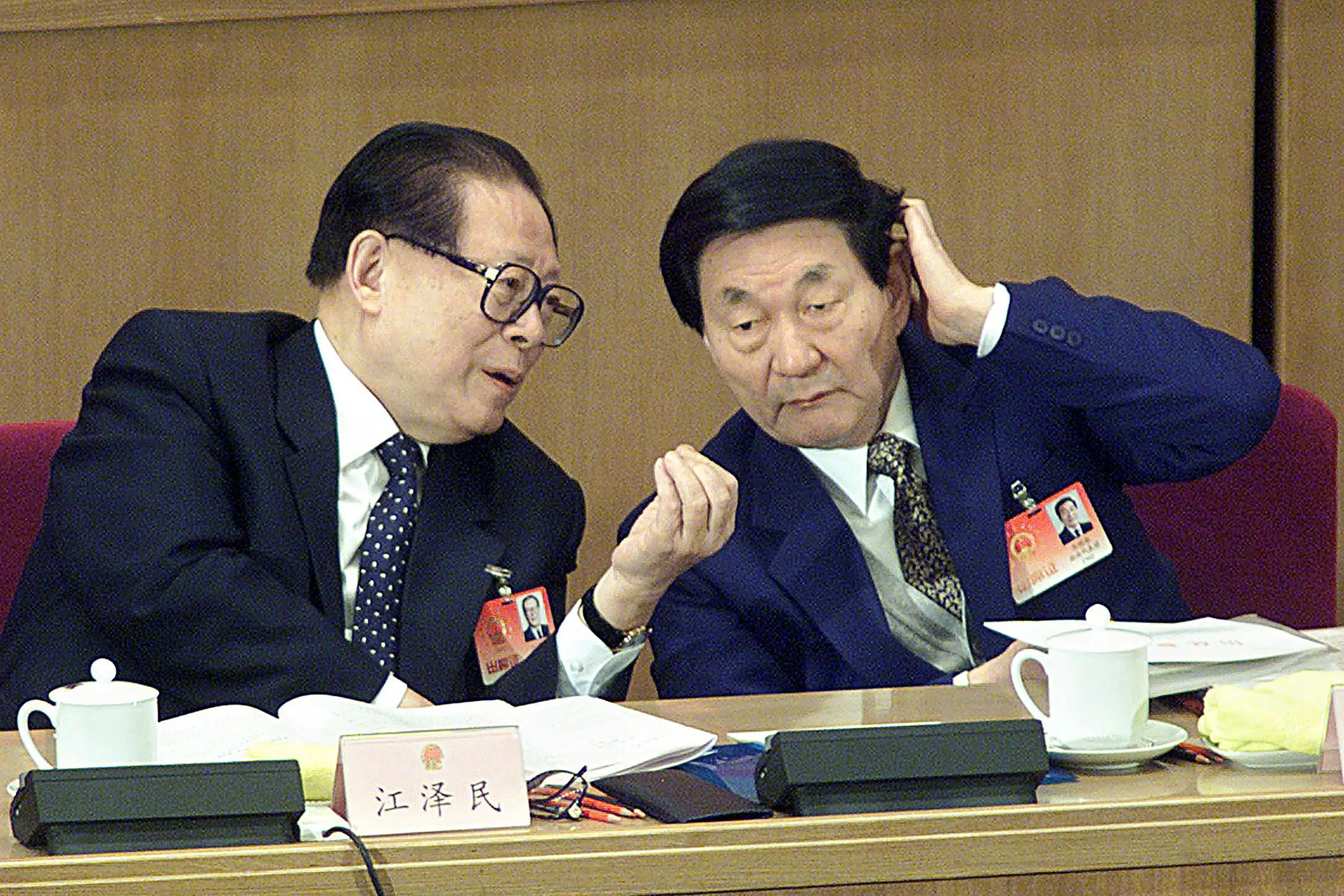 Chinese Premier Zhu Rongji (right) listens to President Jiang Zemin at the National People's Congress (NPC) in the Great Hall of the People in Beijing on 6 March 2002.