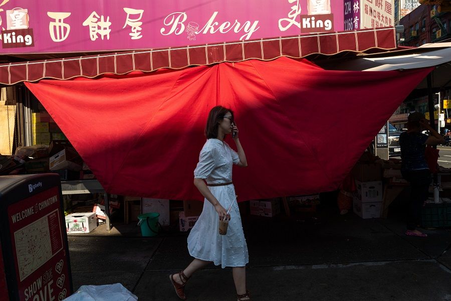 A woman walks through Chinatown in Manhattan on a hot afternoon on 4 August 2022 in New York City, US. (Spencer Platt/Getty Images/AFP)