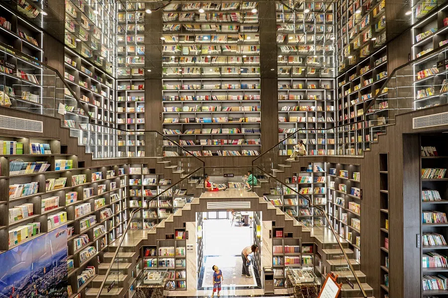 Children read at a bookstore in Zixing, in central China’s Hunan province on 12 August 2024. (AFP)