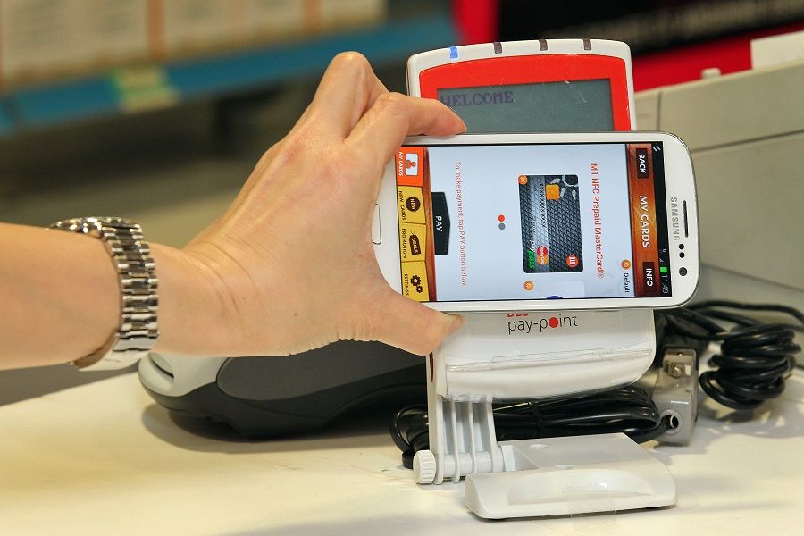 A mobile phone equipped with a near field communication (NFC) capability can be used to pay for purchases, as pictured at a Watsons store in Raffles City Shopping Centre, Singapore. (SPH)