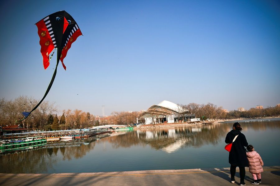 A kite flies in a park ahead of Lunar New Year celebrations, in Beijing, China, 10 February 2021. (Thomas Peter/Reuters)
