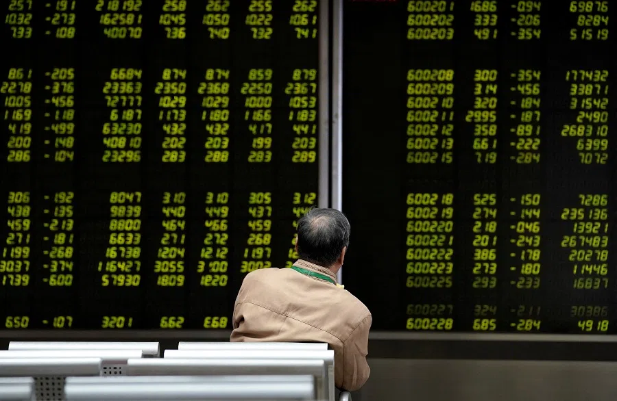 An investor watches a board showing stock information at a brokerage office in Beijing, China, 8 October 2018. (Jason Lee/Reuters)