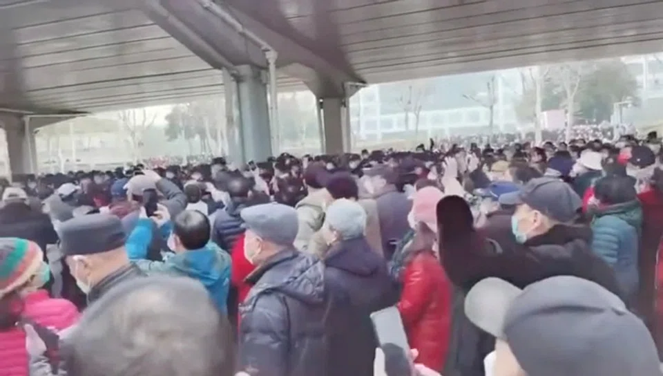 Demonstrators gather outside Zhongshan park to protest changes to medical benefits in Wuhan, China, 15 February 2023 in this still image from social media video obtained by Reuters. (Social media/Reuters)