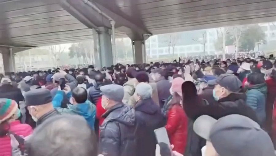 Demonstrators gather outside Zhongshan park to protest changes to medical benefits in Wuhan, China, 15 February 2023 in this still image from social media video obtained by Reuters. (Social media/Reuters)