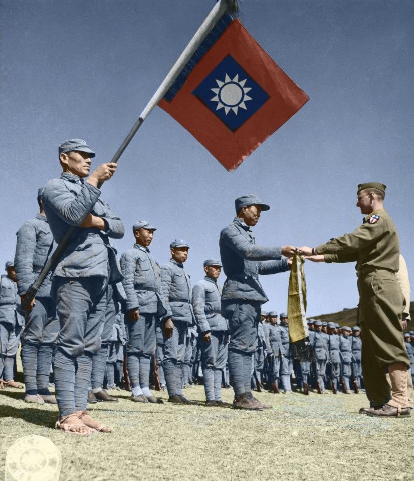 12 February 1944, unidentified training centre - Completing the training, Capt. Lin Yu-kun, commander of demonstration company, 53rd Army, on behalf of all the Chinese trainees, presents a banner to American Instructor, Capt. Herman Friedburg.