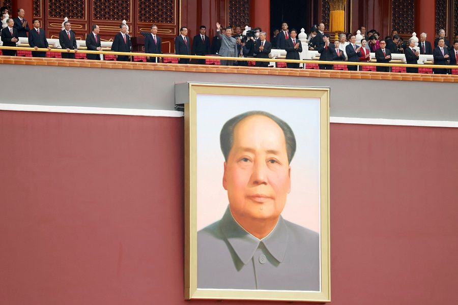 Chinese President Xi Jinping waves above a giant portrait of late Chinese Chairman Mao Zedong at the end of the event marking the 100th founding anniversary of the Communist Party of China, on Tiananmen Square in Beijing, China, 1 July 2021. (Carlos Garcia Rawlins/File Photo/Reuters)