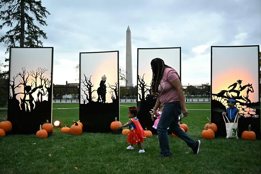 A woman and her child participate in a Halloween celebration at the White House in Washington, DC, on 30 October 2023. (Mandel Ngan/AFP)