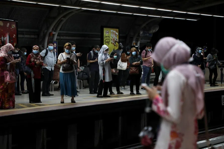People wait for Light Rail Transit train at a station in Kuala Lumpur, Malaysia, 1 October 2020. (Lim Huey Teng/REUTERS)