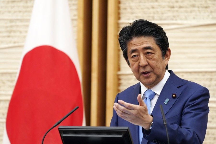 Japanese Prime Minister Shinzo Abe speaks during a news conference in Tokyo, 4 May 2020. Japan extended its nationwide state of emergency until May 31. (Eugene Hoshiko/Bloomberg)