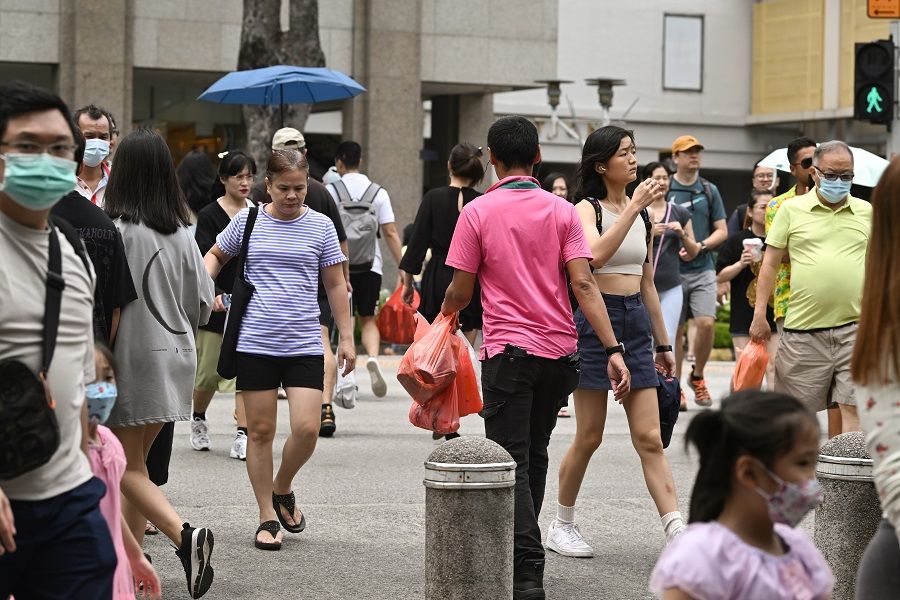 Pedestrians crossing the road towards Bugis Street, Singapore, 7 April 2023. (SPH Media)