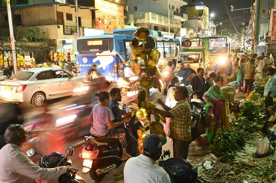 People buy decorative items and essentials at a market on the eve of the Ganesh Chaturthi festival, in Bengaluru, India, on 6 September 2024. (Idrees Mohammed/AFP)