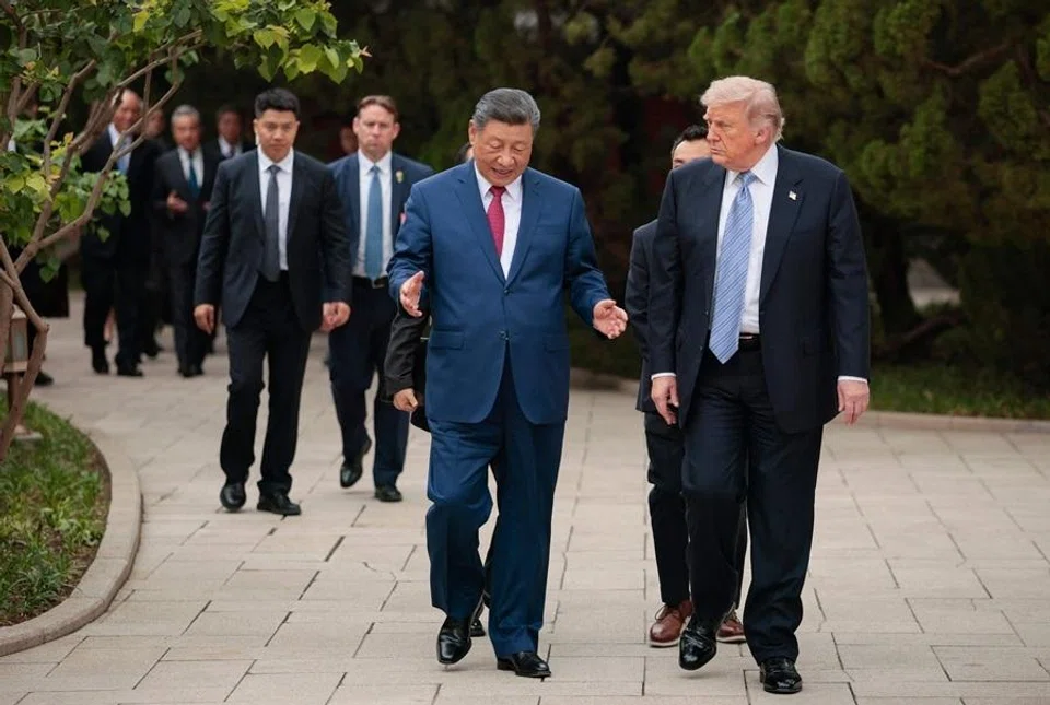 US President Donald Trump (right) walks with Chinas President Xi Jinping (centre) as he leaves after a visit to Zhongnanhai Garden in Beijing on 15 May 2026. (Evan Vucci/AFP)
