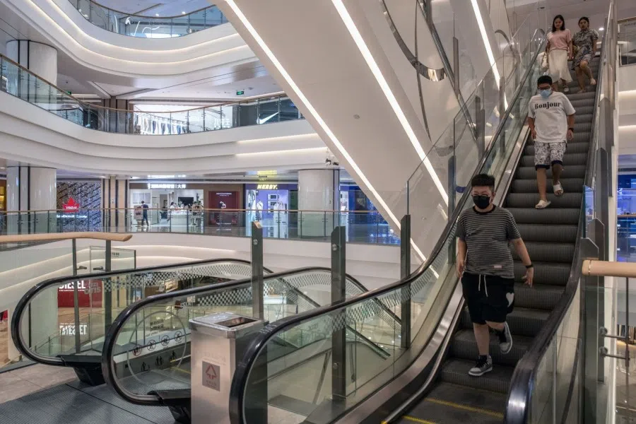 Shoppers walk down an escalator, temporarily shut down to preserve electricity, at a shopping mall in Wuhan, China, on 22 August 2022. (Bloomberg)