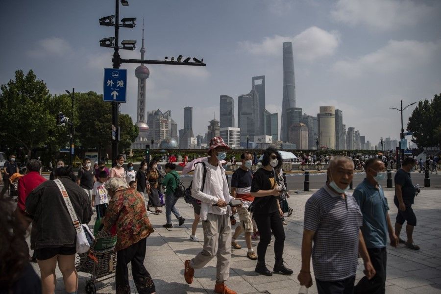 Visitors walk down Nanjing Road in Shanghai, China, on 2 October 2022. (Qilai Shen/Bloomberg)