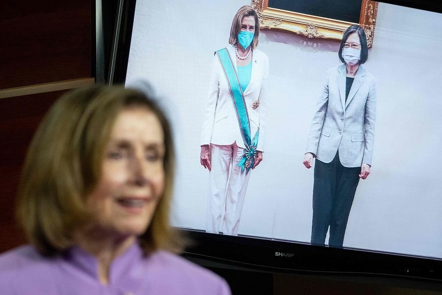 An image of US House Speaker Nancy Pelosi meeting with Taiwan's President Tsai Ing-wen during her stop in Taiwan is displayed as Speaker Pelosi speaks during a press conference on Capitol Hill in Washington, DC, US, on 10 August 2022. (Saul Loeb/AFP)