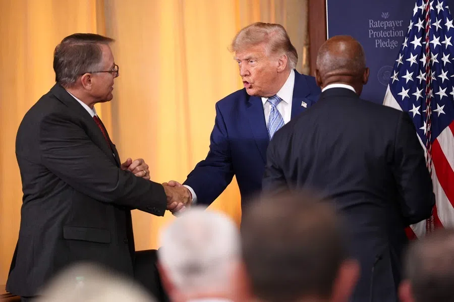 US President Donald Trump shakes hands with Doug Duncan following a data centres roundtable on the Ratepayer Protection Pledge at the Environmental Protection Agency headquarters in Washington, DC, on 23 July 2026.