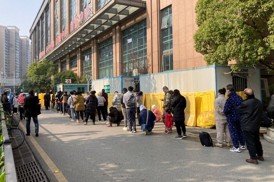 People line up at a fever clinic of The Central Hospital of Wuhan, after the government gradually loosened coronavirus disease (Covid-19) restrictions, in Wuhan, Hubei province, China, 9 December 2022. (Martin Pollard/Reuters)