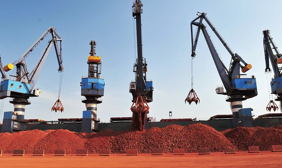 A ship carrying bauxite from Guinea is unloaded at a port in Yantai, Shandong province, China, 15 May 2017. (Stringer/File Photo/Reuters)