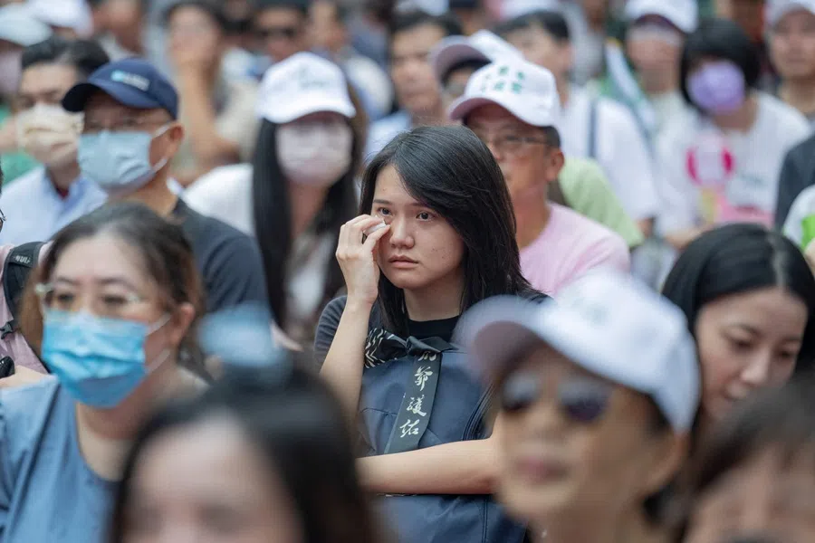 A woman reacts as she awaits the results of the recall election in Taipei on 26 July 2025. (Yu Chien Huang/AFP)