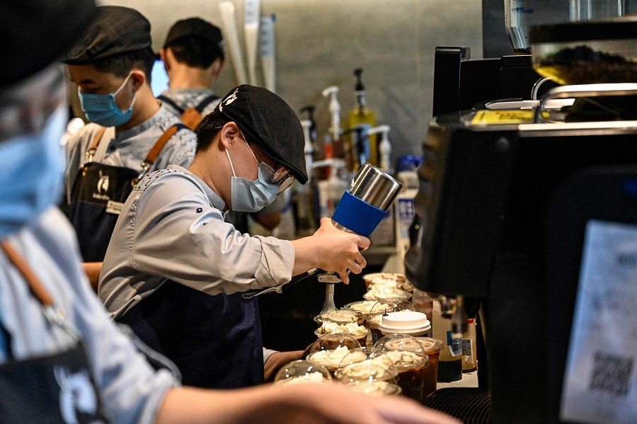 Luckin Coffee employees prepare drinks at a Luckin Coffee shop in Beijing, China, on 4 September 2023. (Jade Gao/AFP)