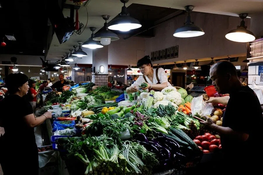 People shop at a wet market in Wenzhou, Zhejiang province, China, on 11 July 2026.