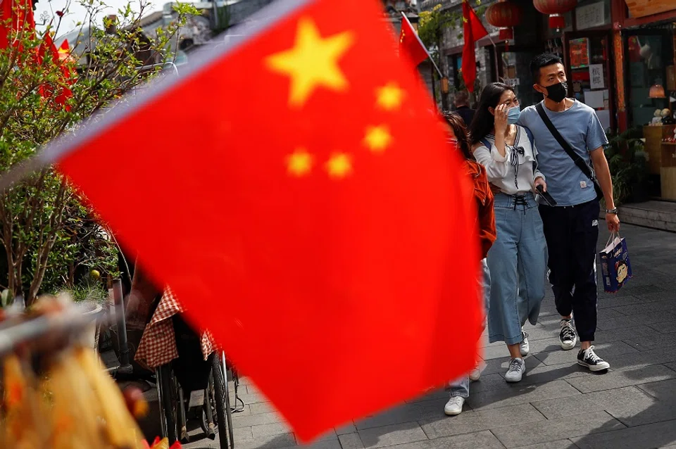 People walk in the tourist area surrounding Houhai Lake during Chinese National Day holidays in Beijing, China, 2 October 2020. (Thomas Peter/Reuters)
