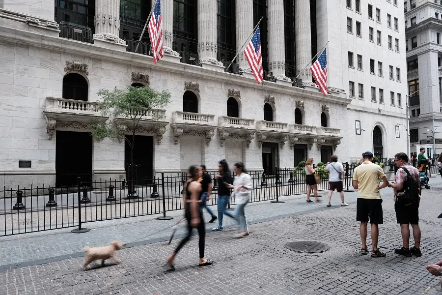 People walk by the New York Stock Exchange on 26 August 2022 in New York City, US. (Spencer Platt/Getty Images/AFP)