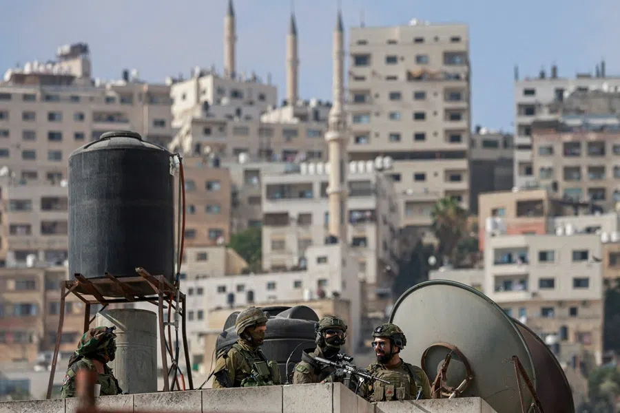 Israeli troops take position atop a building during a raid in Nablus city in the occupied West Bank on 27 August 2025.