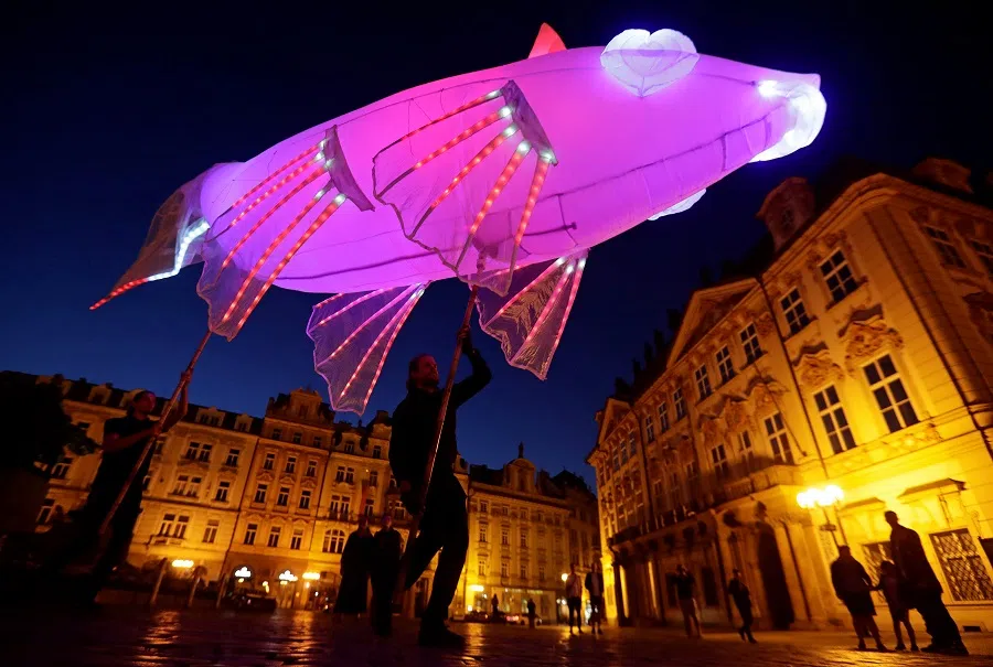 Artists perform at the Old Town Square during a street theater festival in Prague, Czech Republic, 12 July 2020. (David W Cerny/Reuters)