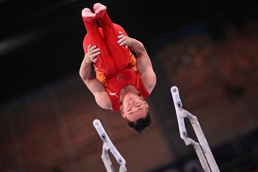 China's Xiao Ruoteng competes in the parallel bars event of the artistic gymnastics men's all-around final during the Tokyo 2020 Olympic Games at the Ariake Gymnastics Centre in Tokyo, Japan on 28 July 2021. (Martin Bureau/AFP)