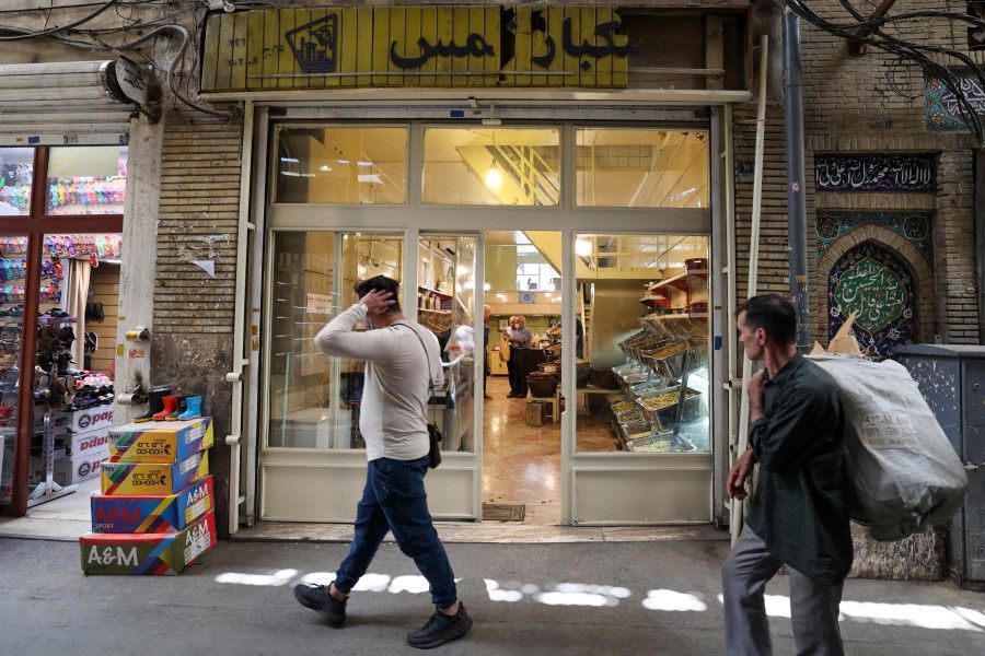 People walk in Tehran's Graz Bazaar on 19 June 2022. (Atta Kenare/AFP)