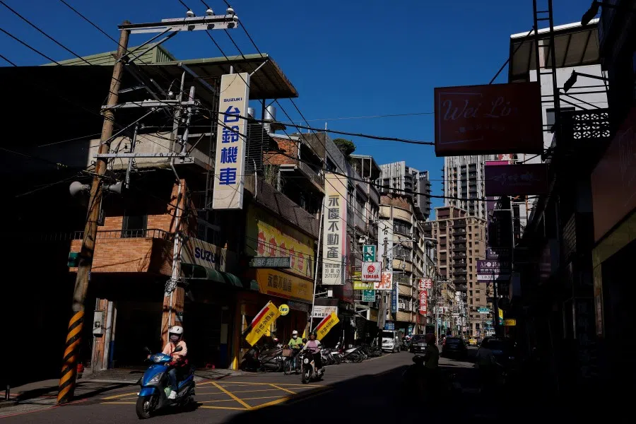 People commute on their motorbikes in the morning in New Taipei City, Taiwan, on 9 November 2023. (Ann Wang/Reuters)