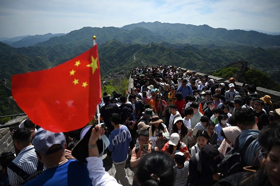 People climb the Great Wall of China at Badaling, north of Beijing, China on 1 May 2024. (Greg Baker/AFP)